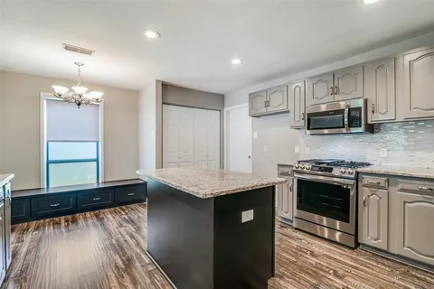 a kitchen with stainless steel appliances granite countertop a stove and a sink
