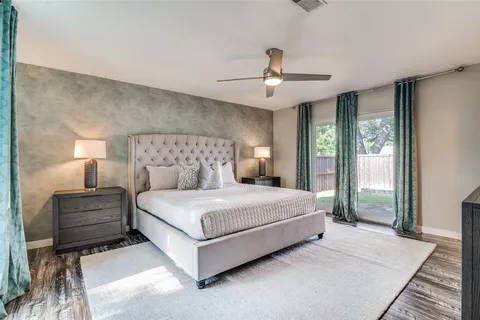 a bedroom with a large bed and a chandelier