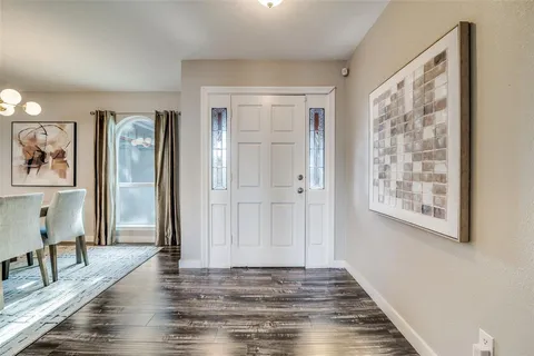 a view of a room with wooden floor and a window
