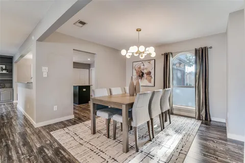 a view of a dining room with furniture and chandelier