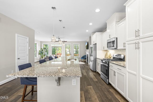 a large kitchen with lots of counter space and stainless steel appliances
