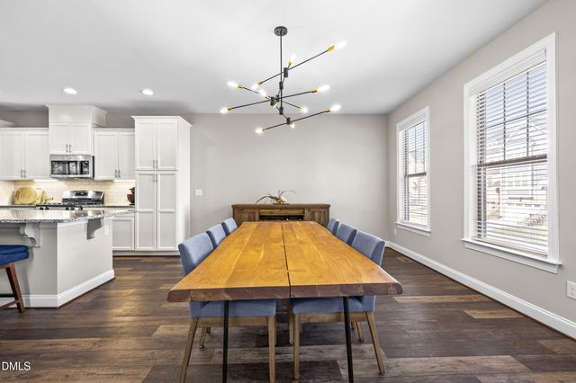 a kitchen with stainless steel appliances granite countertop a kitchen island a stove a refrigerator a kitchen island a sink and a refrigerator