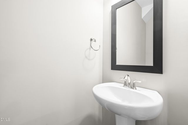 a kitchen with a table chairs a sink dishwasher window and cabinets