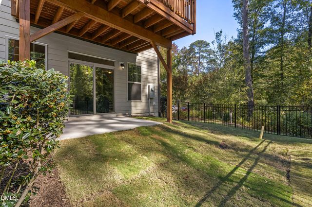 a view of a balcony with wooden floor and fence
