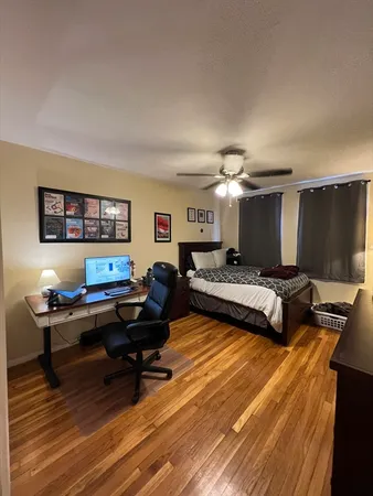 a bedroom with a bed and a desk