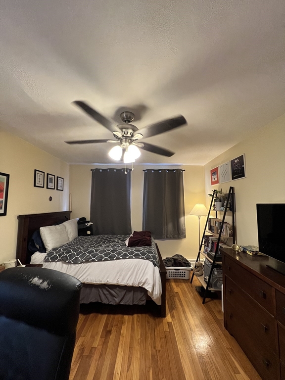 41 Cross Street Somerville, MA 02145 - Photo 18 of 42 a bedroom with a bed and wooden floor