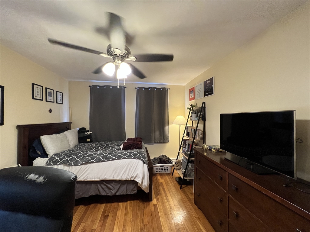 41 Cross Street Somerville, MA 02145 - Photo 19 of 42 a bedroom with a bed and a flat screen tv