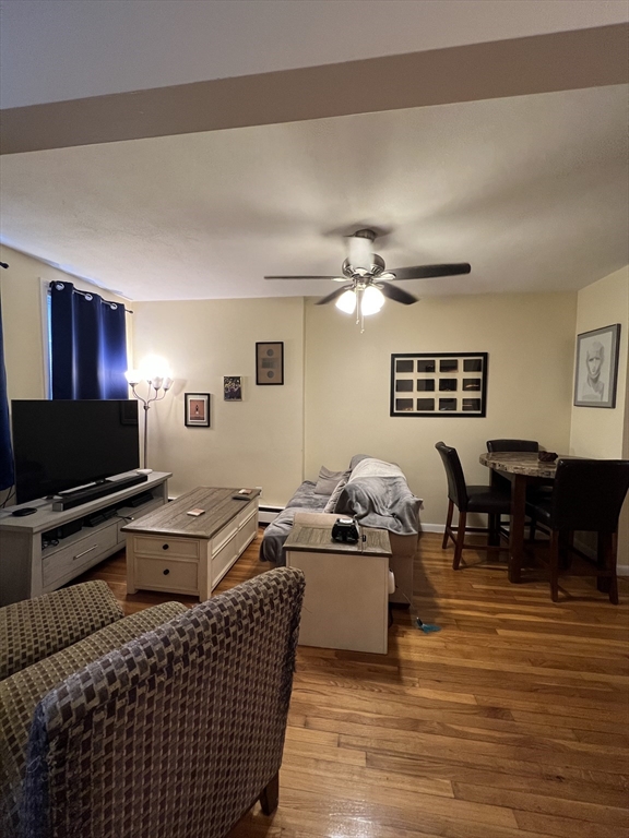 41 Cross Street Somerville, MA 02145 - Photo 2 of 42 a living room with furniture and a flat screen tv