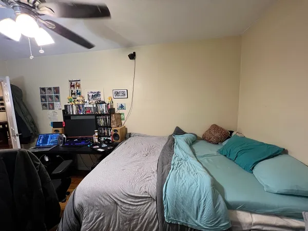 a bedroom with a bed and a flat screen tv