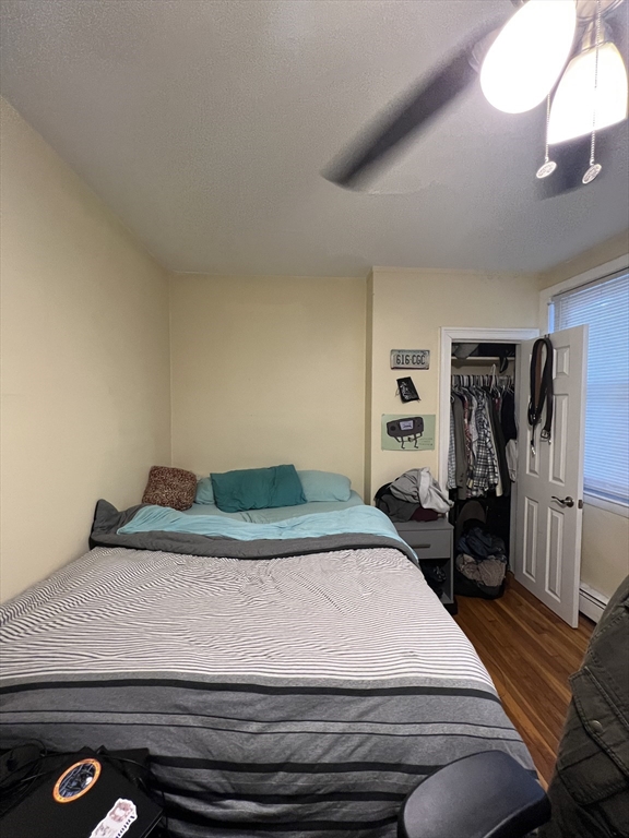 41 Cross Street Somerville, MA 02145 - Photo 24 of 42 a bedroom with a bed and wooden floor