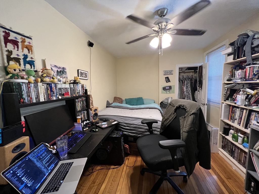 41 Cross Street Somerville, MA 02145 - Photo 25 of 42 a bedroom with a bed and a book shelf