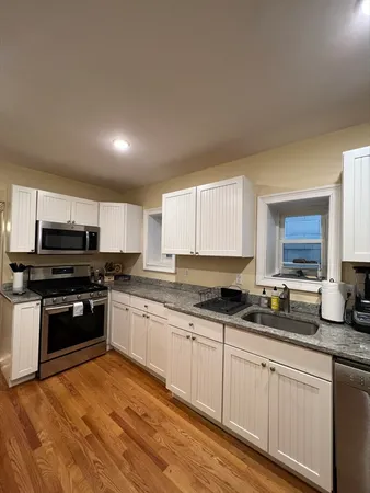 a kitchen with stainless steel appliances granite countertop a stove and a sink