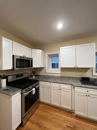 a kitchen with a sink and steel appliances