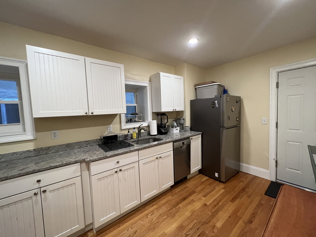 41 Cross Street Somerville, MA 02145 - Photo 42 of 42 a kitchen with granite countertop a refrigerator and a sink
