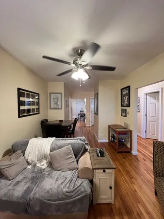 a bedroom with furniture and a wooden floor
