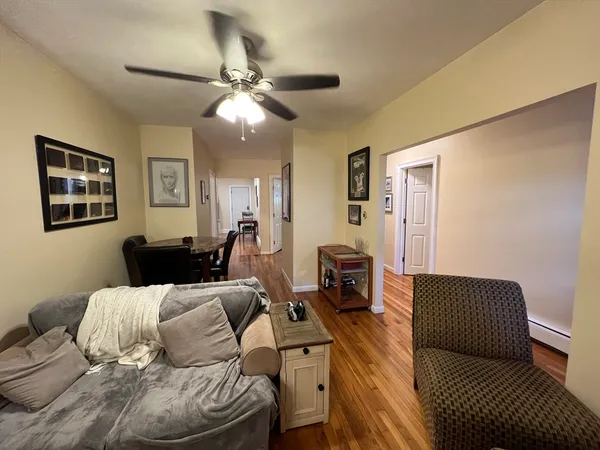 a living room with furniture and a chandelier