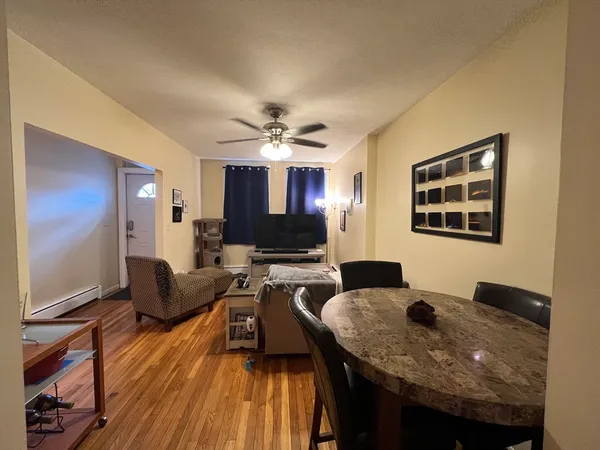 a view of a dining room with furniture and wooden floor