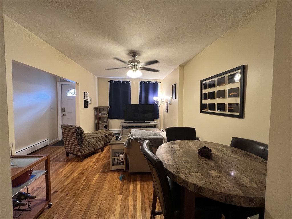41 Cross Street Somerville, MA 02145 - Photo 9 of 42 a view of a dining room with furniture and wooden floor
