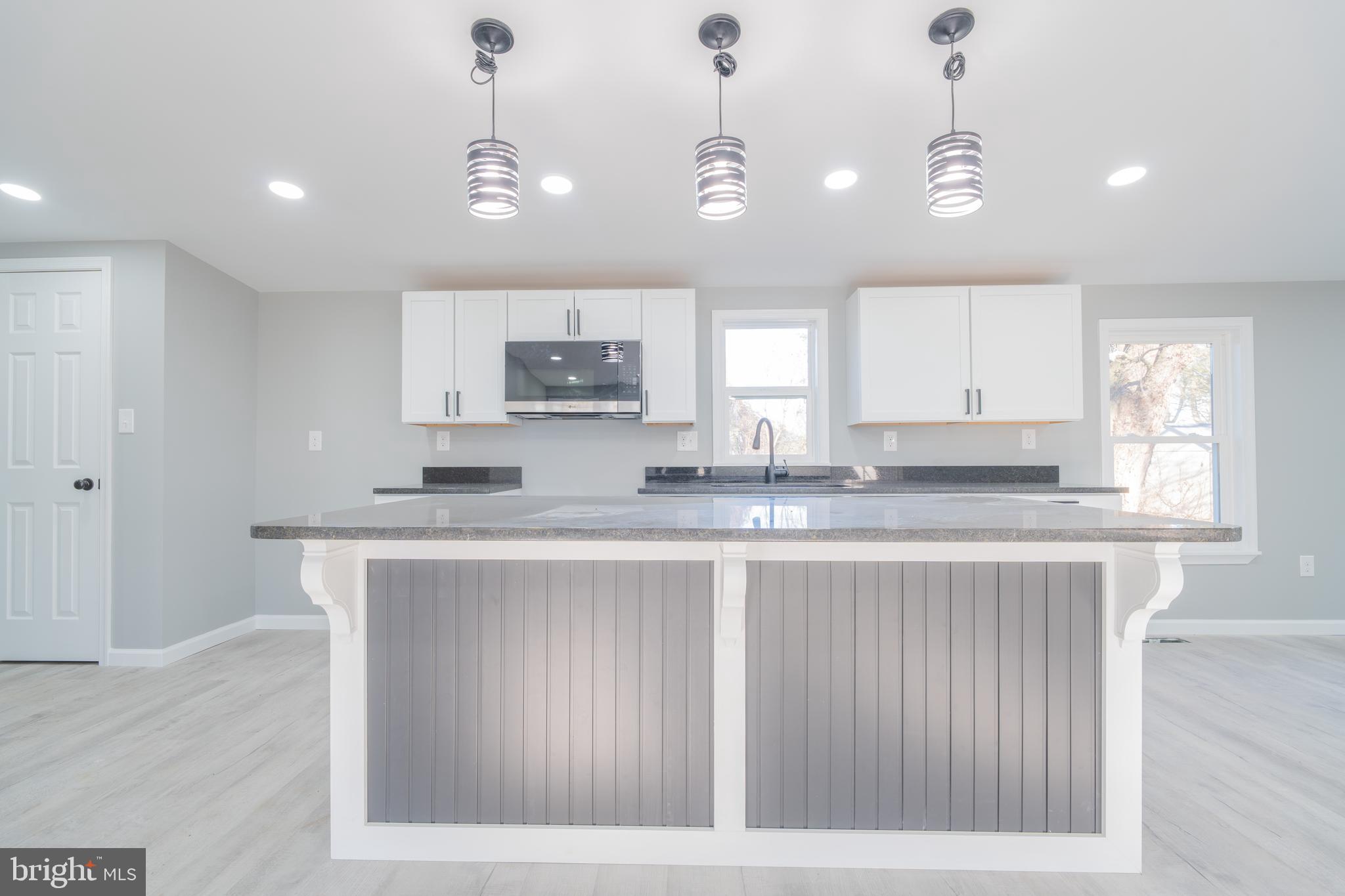 12579 Whitesville Road Laurel, DE 19956 - Photo 15 of 25 a kitchen with kitchen island granite countertop a sink cabinets and window