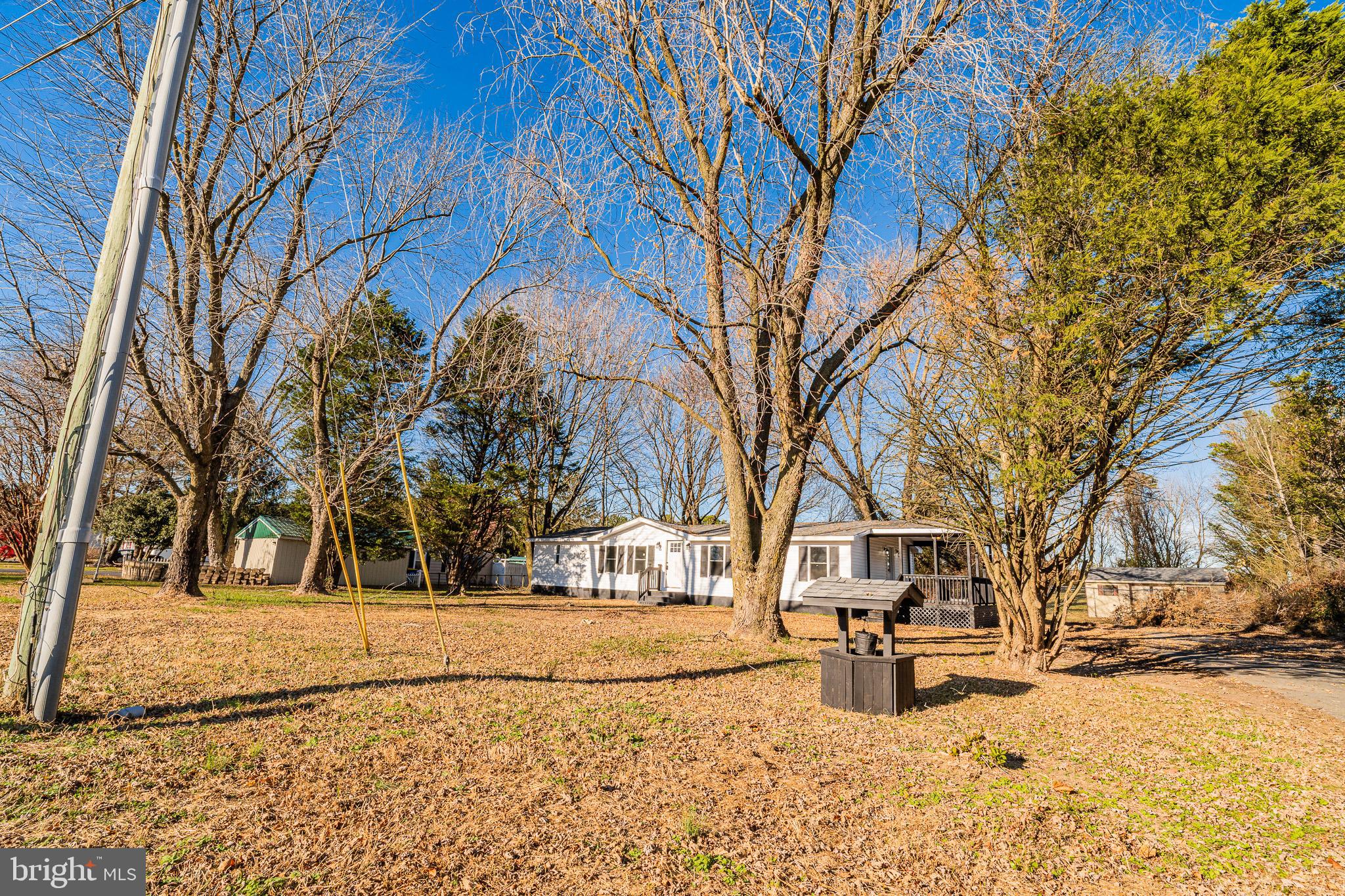 12579 Whitesville Road Laurel, DE 19956 - Photo 2 of 25 a wooden bench sitting in front of house