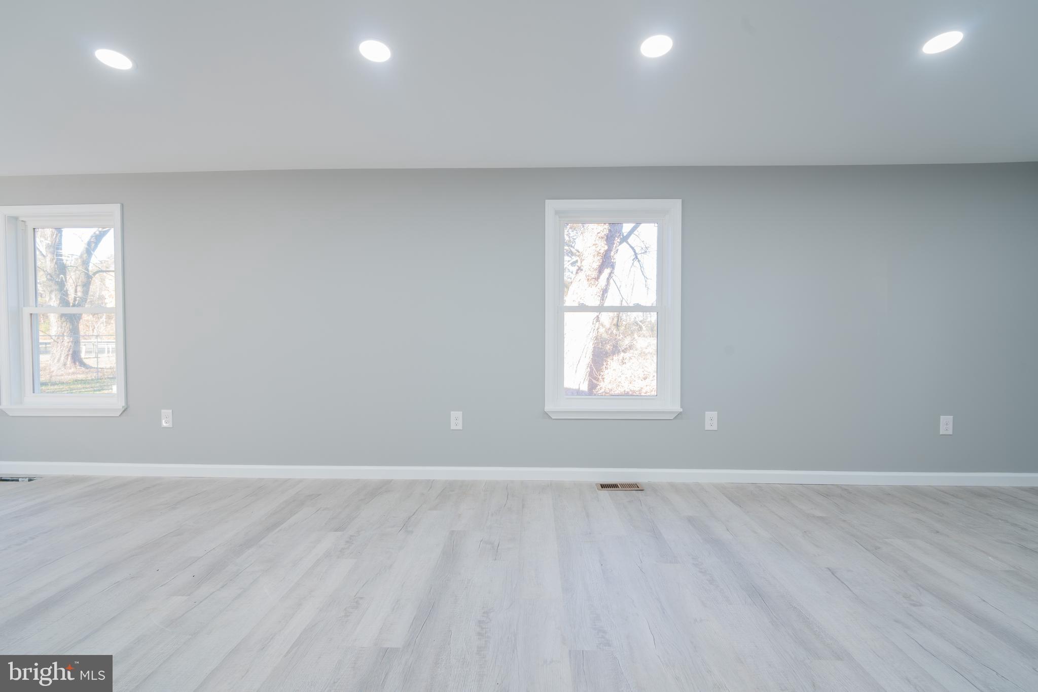 12579 Whitesville Road Laurel, DE 19956 - Photo 24 of 25 an empty room with wooden floor and windows