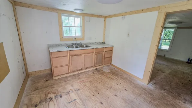 a spacious bathroom with a sink and a mirror