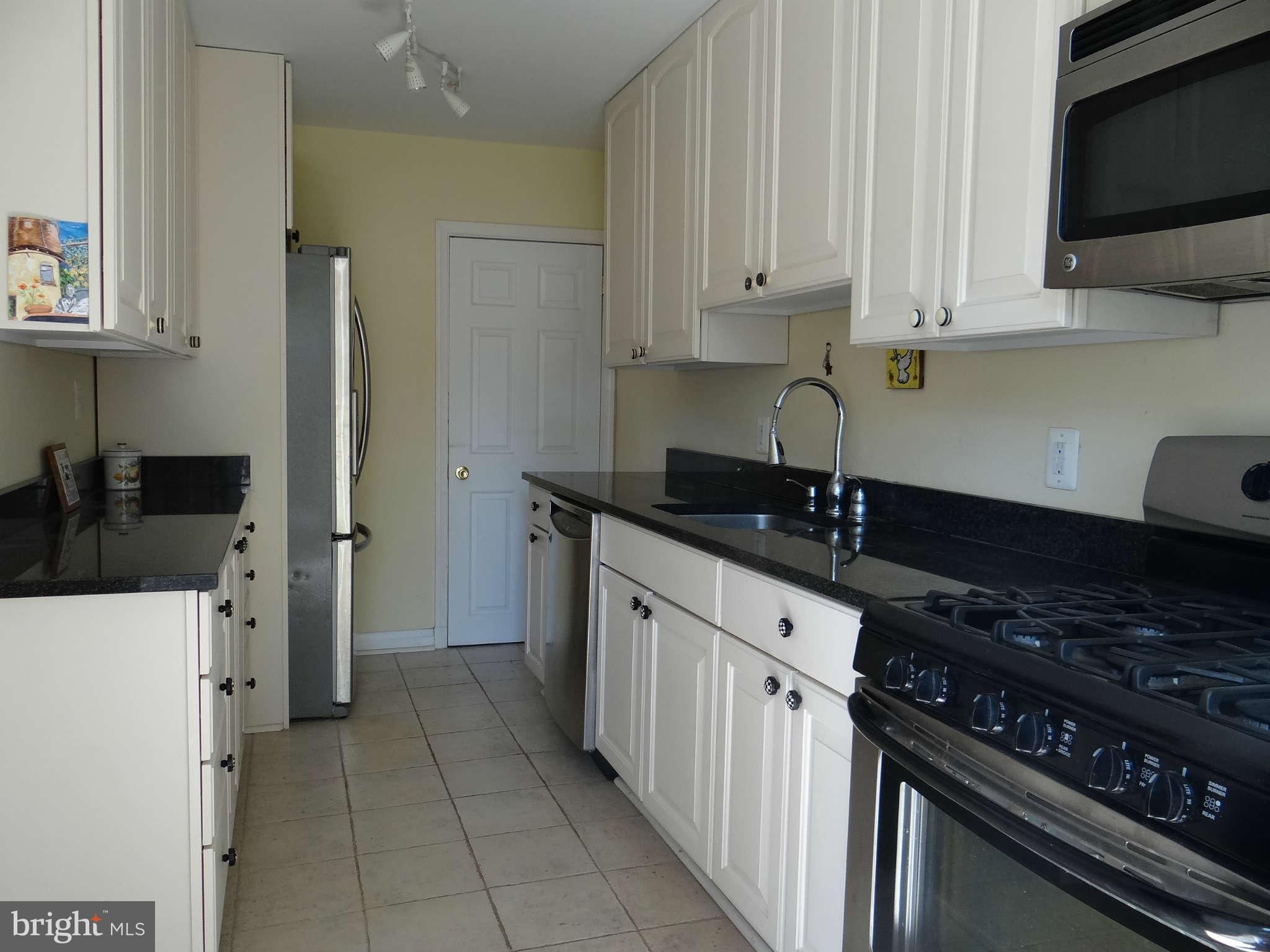 101 Stanmore Road Baltimore, MD 21212 - Photo 11 of 25 a kitchen with stainless steel appliances a sink stove and cabinets
