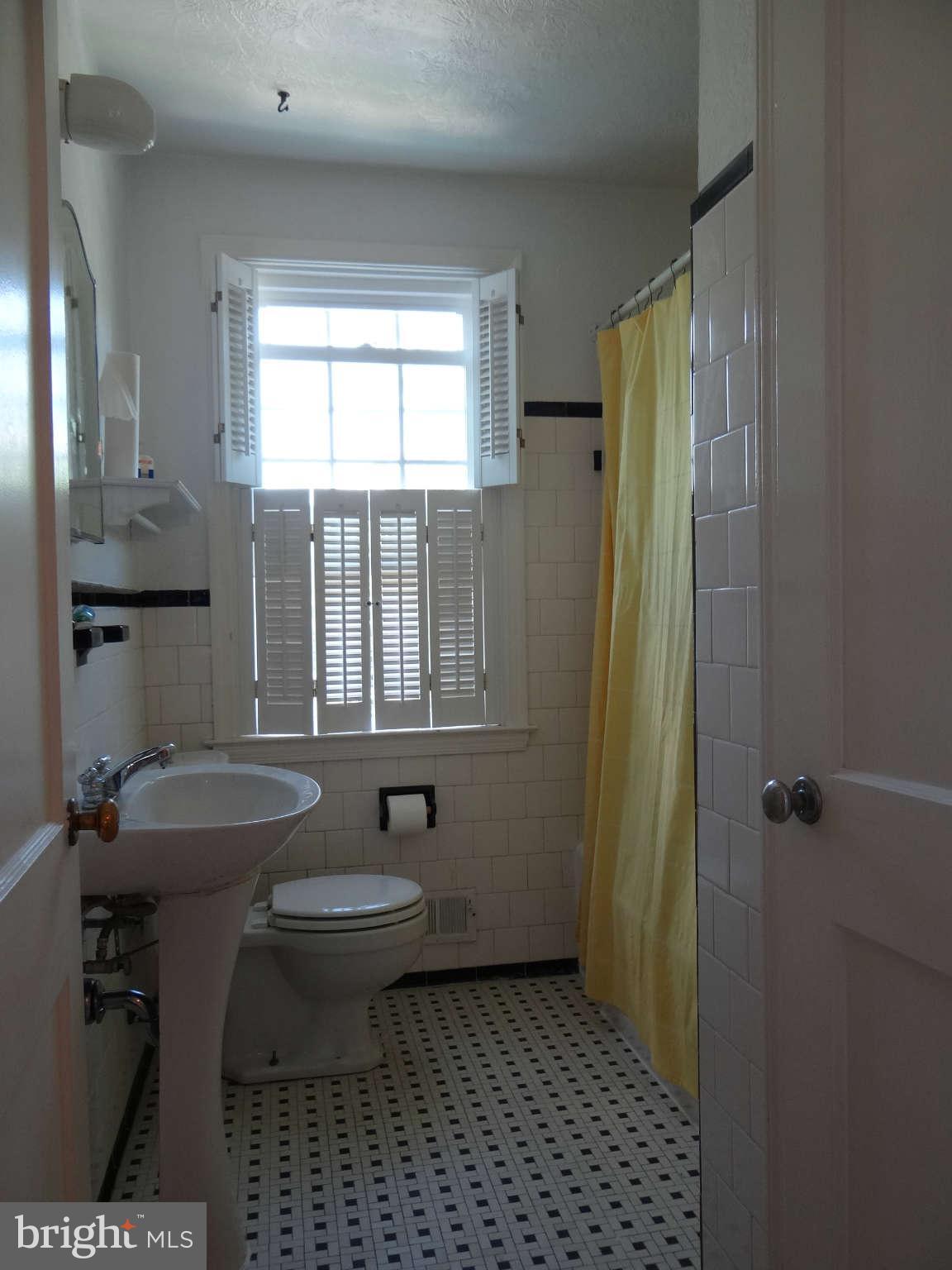101 Stanmore Road Baltimore, MD 21212 - Photo 15 of 25 a bathroom with a sink a toilet a window and shower
