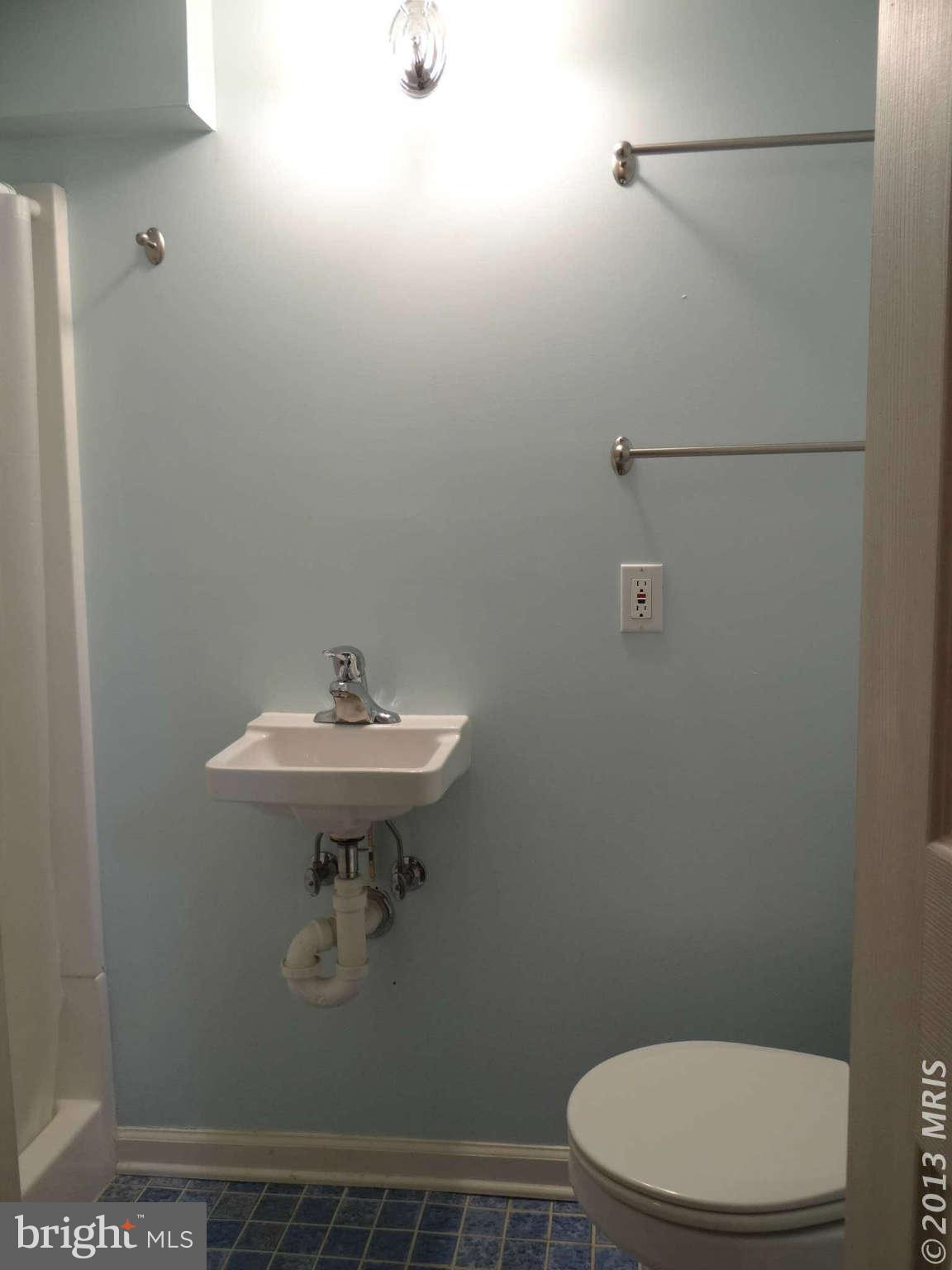 101 Stanmore Road Baltimore, MD 21212 - Photo 22 of 25 a bathroom with a sink a toilet and a mirror