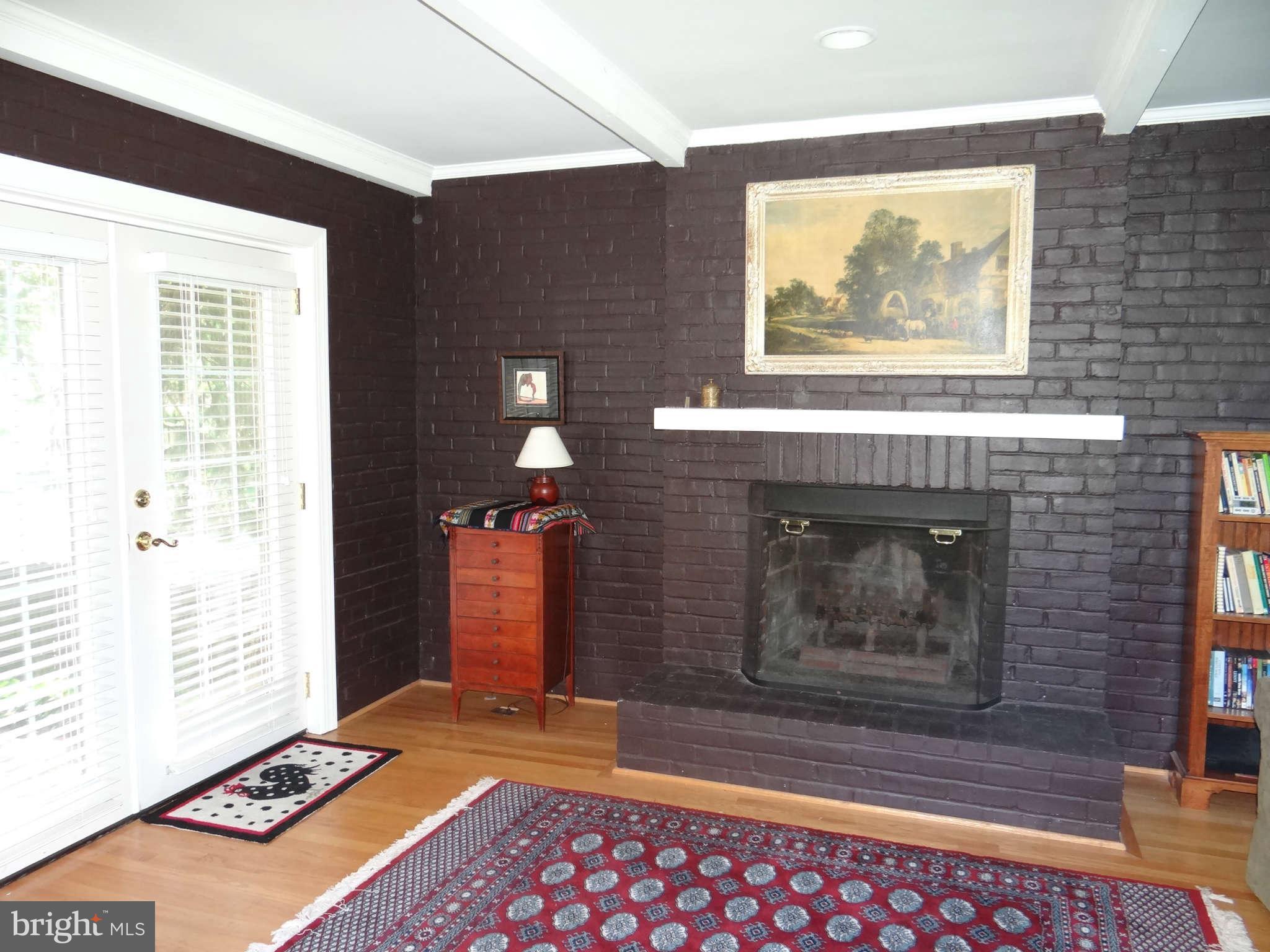 101 Stanmore Road Baltimore, MD 21212 - Photo 9 of 25 a view of an empty room with a fireplace and a window