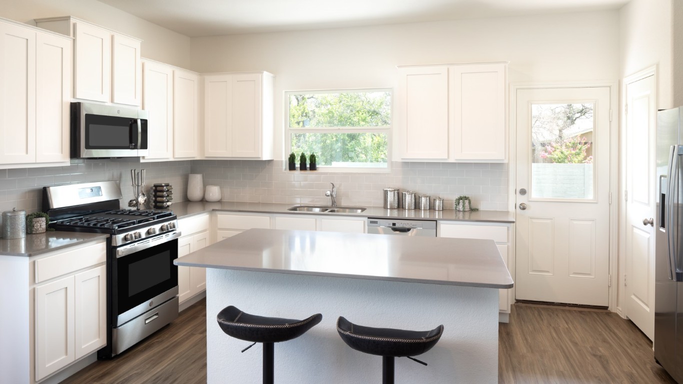 3275 Everett Kyle, TX 78640 - Photo 8 of 13 a kitchen with stainless steel appliances granite countertop a stove a sink and a microwave