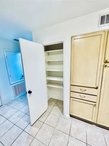 a view of kitchen with wooden floor and electronic appliances
