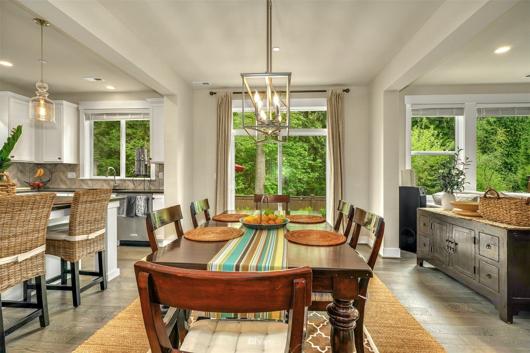 3312 238th Place Southeast Bothell, WA 98021 - Photo 15 of 40 a dining room with furniture a chandelier and wooden floor