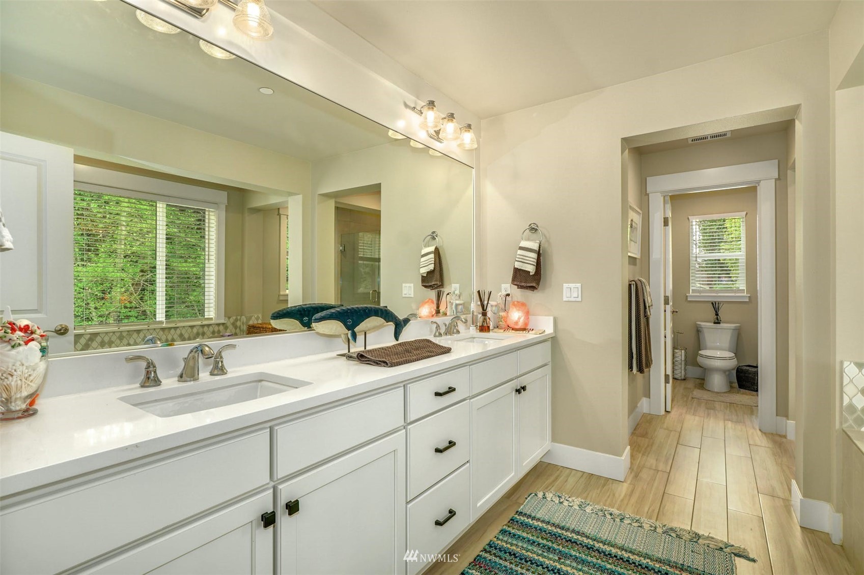 3312 238th Place Southeast Bothell, WA 98021 - Photo 24 of 40 a en suite bathroom with a double vanity sink a mirror and a shower