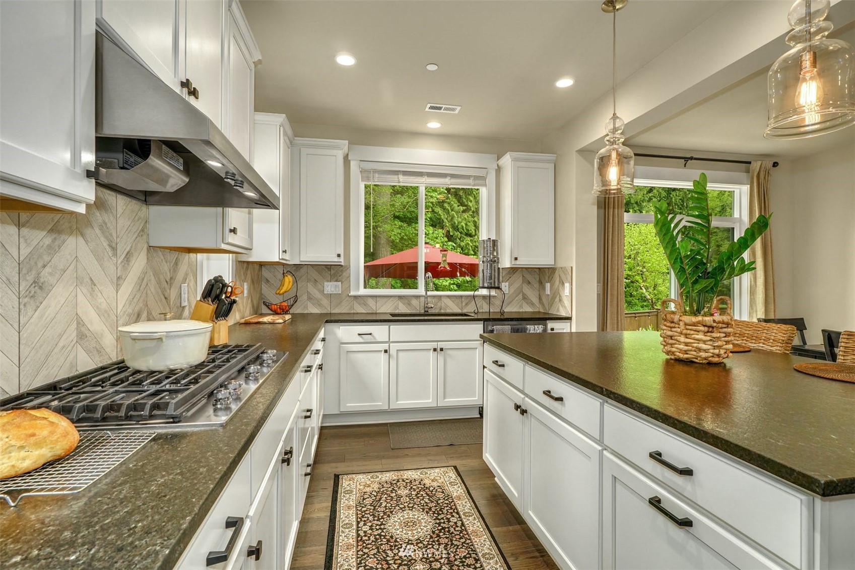 3312 238th Place Southeast Bothell, WA 98021 - Photo 10 of 40 a kitchen with a stove a sink and a wooden cabinets