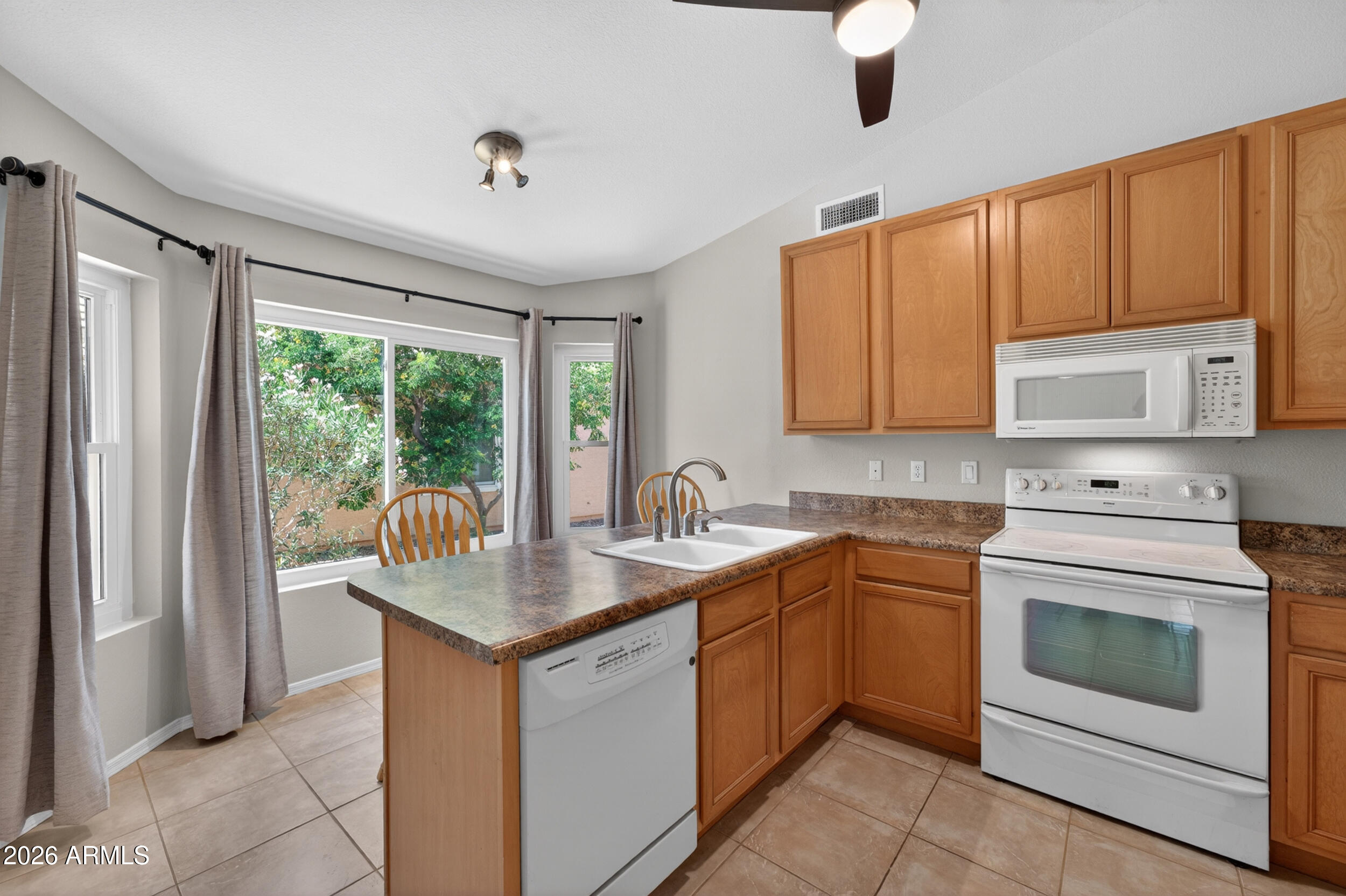 4729 West Monterey Street Chandler, AZ 85226 - Photo 16 of 50 a kitchen with stainless steel appliances granite countertop a stove sink and microwave