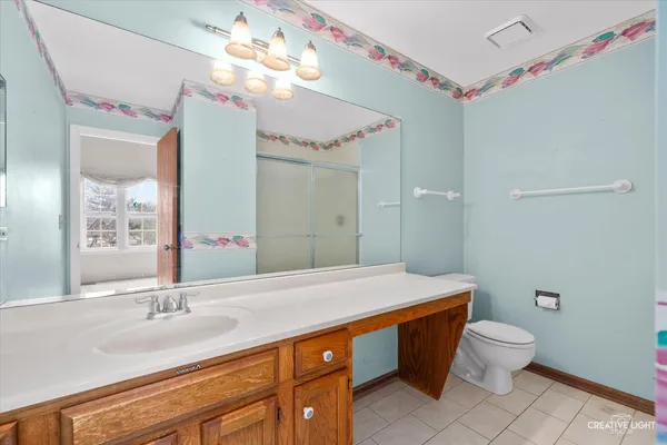 a bathroom with a sink a toilet and a mirror