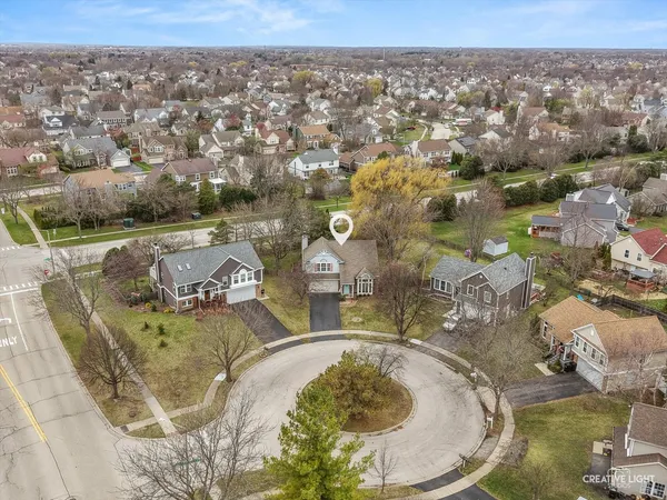 an aerial view of a house with yard swimming pool and lake view