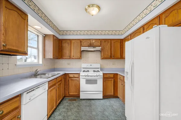 a kitchen with a stove a sink and a refrigerator