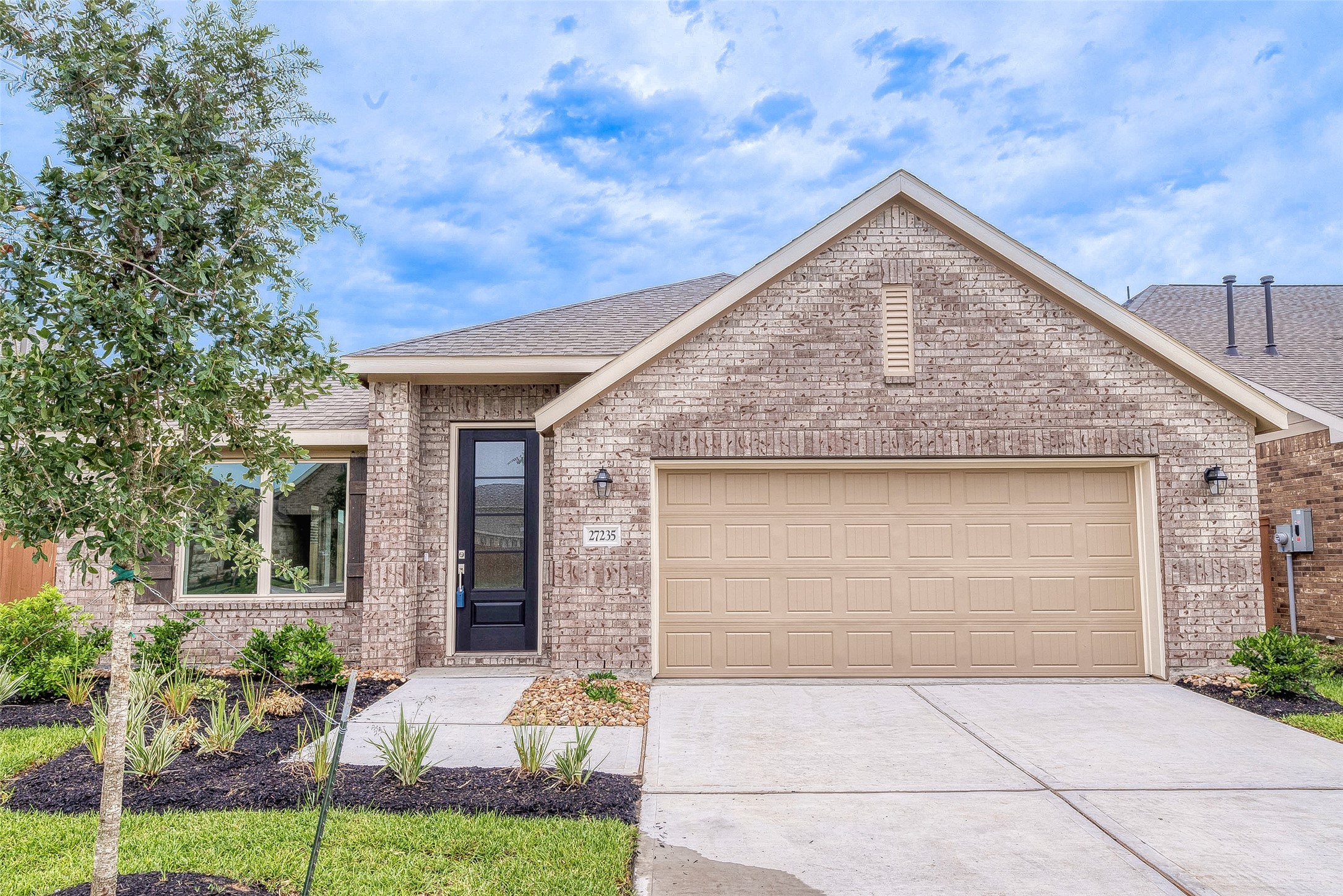 27235 Henley Rdg Drive Katy, TX 77493 - Photo 2 of 28 a front view of a house with garden