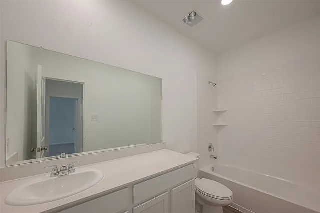 a bathroom with a sink vanity and mirror