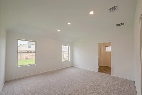 an empty room with windows and closet