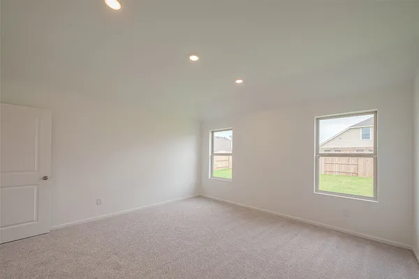 an empty room with windows and closet