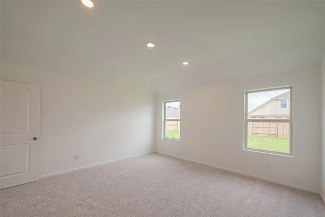 an empty room with windows and closet