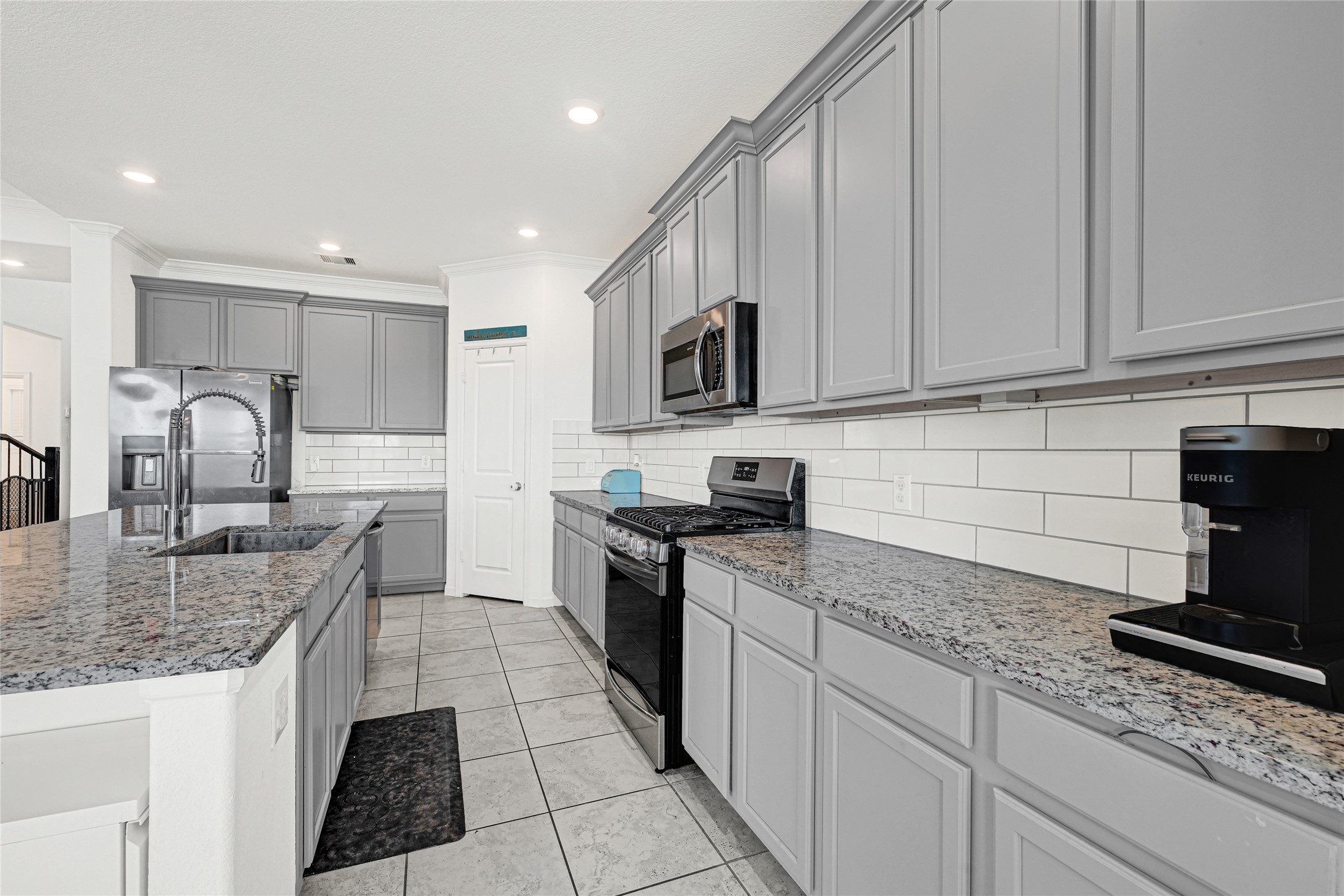 4307 Annandale Lane Rosharon, TX 77583 - Photo 4 of 31 a kitchen with stainless steel appliances granite countertop a sink stove and cabinets
