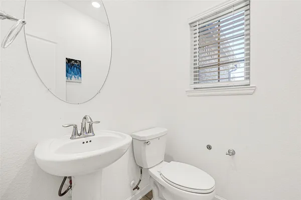 a bathroom with a sink a mirror and a toilet