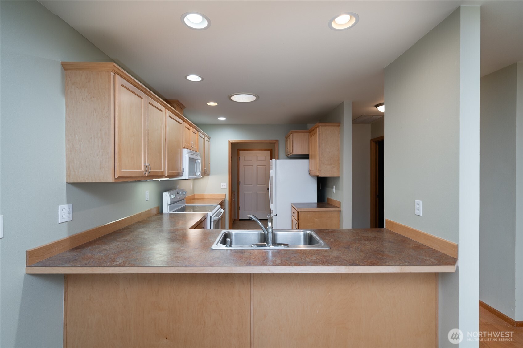 1202 Decatur Circle, Unit 20B Burlington, WA 98233 - Photo 11 of 38 a kitchen with stainless steel appliances granite countertop a sink a refrigerator and a granite counter tops
