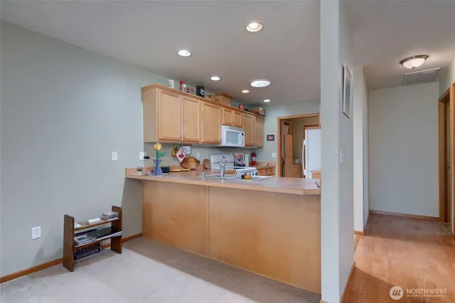 a kitchen with stainless steel appliances granite countertop a refrigerator and a sink