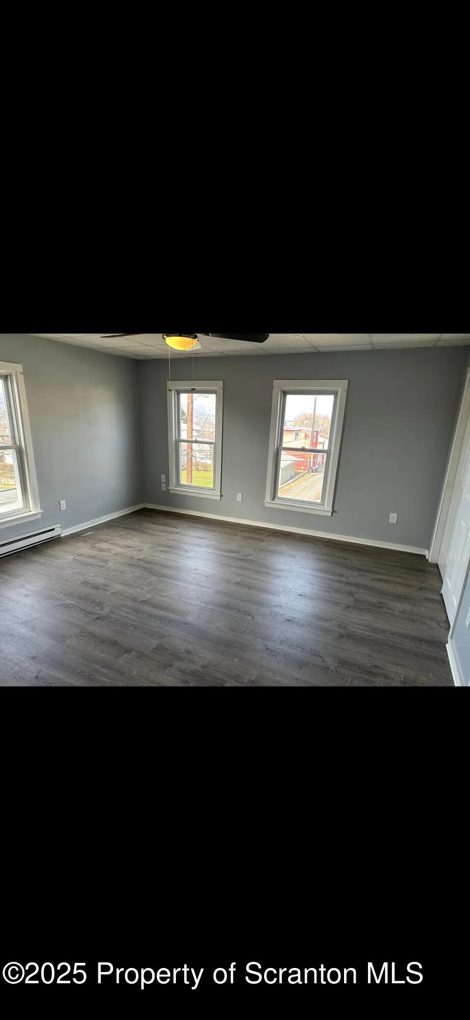 618 Gibbons Street, Unit 2 Scranton, PA 18505 - Photo 9 of 19 a view of an empty room with wooden floor and a window