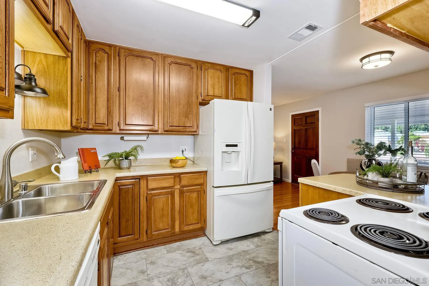 9307 Manor Drive La Mesa, CA 91942 - Photo 11 of 29 a kitchen with a sink a stove and refrigerator